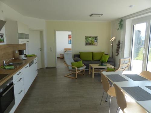 a kitchen and living room with a couch and a table at Komfort Ferienwohnung Wolfhagen in Wolfhagen