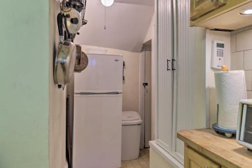 a small kitchen with a refrigerator and a toilet at Historic Ocean Grove Home - Walk to Beach! in Ocean Grove