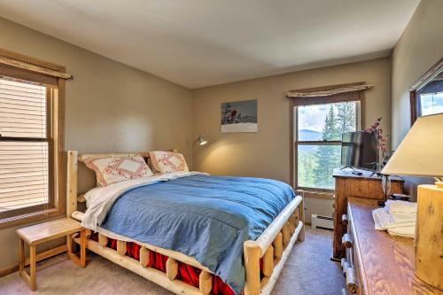 a bedroom with a bed and a desk and two windows at 10 Mi to Keystone Updated Mtn-View Condo in Silverthorne