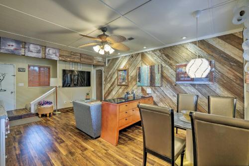 a dining room with a table and a ceiling fan at Luxurious Downtown Lodi Apartment in Wine Country! in Lodi