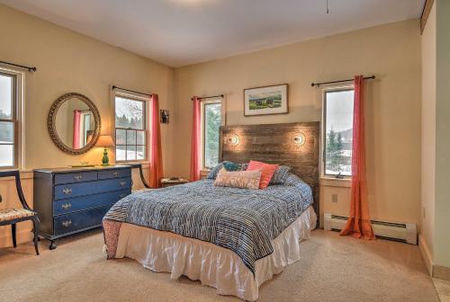 a bedroom with a bed and a dresser and windows at Darling Hill Home on Kingdom Trails-Near Burke Mtn in Lyndon