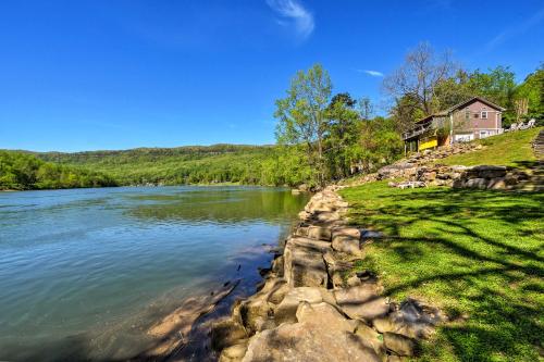 a house on a hill next to a river at Cozy Cabin on Tenn River - 10 Mi to Chattanooga! in Chattanooga