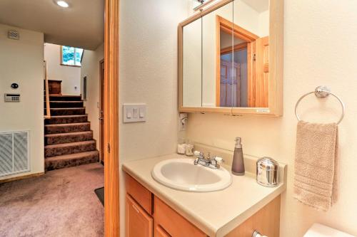 a bathroom with a sink and a mirror and stairs at Forest Views and Beach Access Family Truckee Gem in Truckee