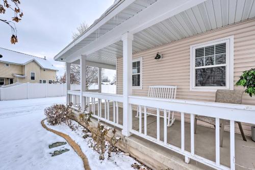 a front porch of a house in the snow at Family-Friendly Logan Farmhouse with Yard and Near USU in Logan