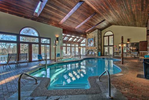 a swimming pool in a house with a ceiling at Ski Condo with Pool, Close to Story Land and Attitash! in Bartlett