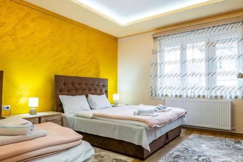 a bedroom with two beds and a window at Vujisić Apartment in the City Center in Kolašin