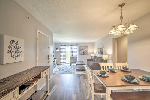 a dining room and living room with a table and chairs at Cozy Condo with Pool Access in the Heart of Branson! in Branson