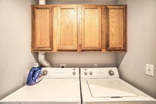 a washing machine in a kitchen with wooden cabinets at Cozy Condo with Pool Access in the Heart of Branson! in Branson