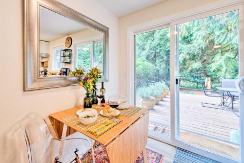 a dining room with a table and a mirror at House with Deck on Whidbey Island, 1 Mi from Shore! in Clinton