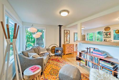 a living room with a couch and a fire place at House with Deck on Whidbey Island, 1 Mi from Shore! in Clinton