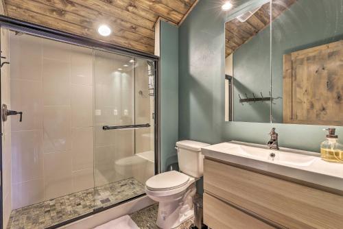 a bathroom with a shower and a toilet and a sink at Updated Cabin with Hot Tub about 11 Mi to Winter Park! in Tabernash