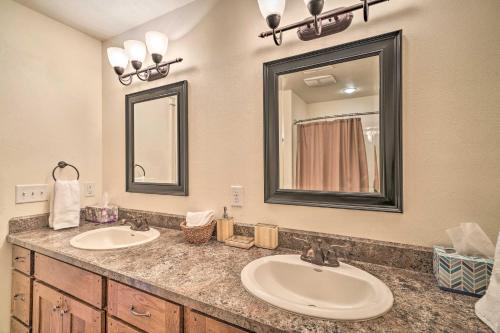 a bathroom with two sinks and a mirror at Updated Townhome with Hot Tub - Walk to Downtown! in Red Lodge