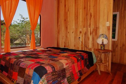 a bedroom with a bed and a window at Casa Alquimia in Monteverde Costa Rica