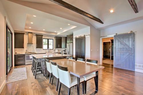 a large kitchen with a wooden table and chairs at Waterfront Silver Lake Home with Private 40 Dock! in Traverse City
