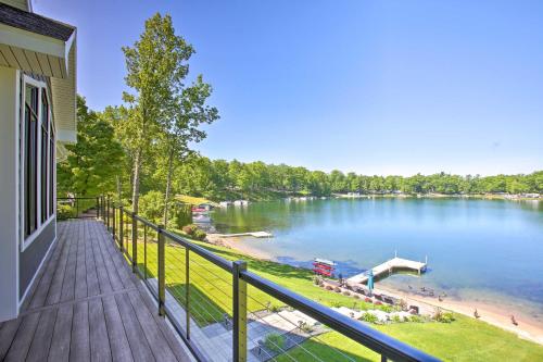 a balcony of a house with a view of a lake at Waterfront Silver Lake Home with Private 40 Dock! in Traverse City