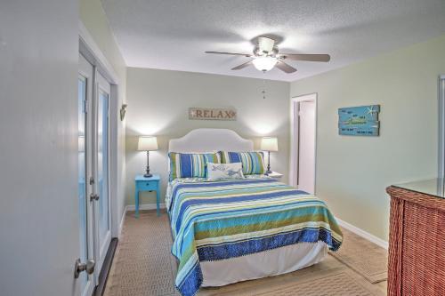 a bedroom with a bed and a ceiling fan at Amelia Island Condo with Pool and Beach Access! in Amelia Island