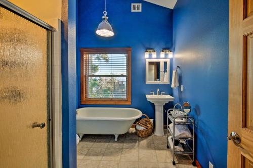 a blue bathroom with a tub and a sink at Puget Sound Escape Private Beach and Oversized Deck in Kingston