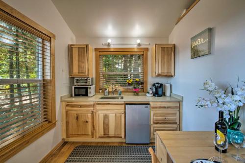 a kitchen with wooden cabinets and a stainless steel refrigerator at Puget Sound Escape Private Beach and Oversized Deck in Kingston