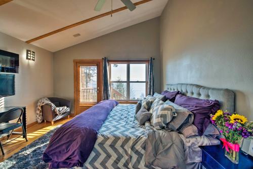 a living room with a large bed with purple sheets at Puget Sound Escape Private Beach and Oversized Deck in Kingston