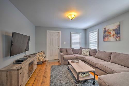 a living room with a couch and a flat screen tv at Warrensburg Home about 6 Mi to Lake George! in Warrensburg
