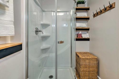 a shower with a glass door in a bathroom at Puget Sound Escape Private Beach and Oversized Deck in Kingston