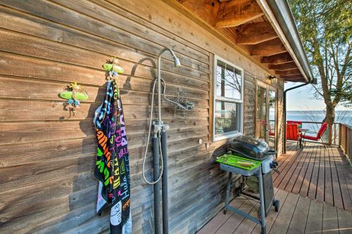a shower on a wooden wall next to a grill at Puget Sound Escape Private Beach and Oversized Deck in Kingston