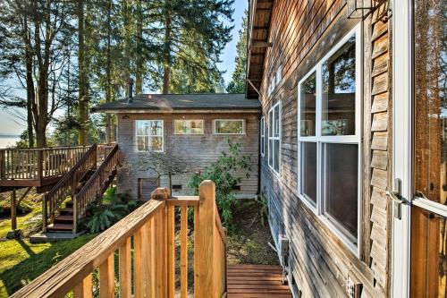 a tiny house with a porch and a deck at Puget Sound Escape Private Beach and Oversized Deck in Kingston