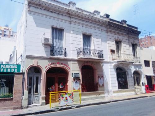 a white building on the corner of a street at Santa Rosa in Cordoba