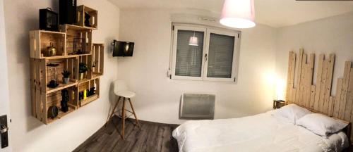 a bedroom with a bed and a window at Appart Vosges in Fresse-sur-Moselle