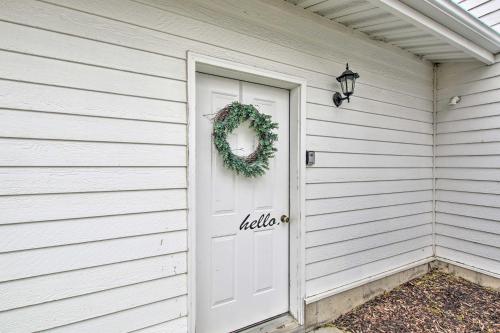 a white house with a white door and a wreath at North Logan Studio, Walk to Utah State Campus! in Logan
