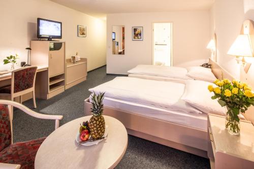 A bed or beds in a room at Gasthof Enge Self Check-In Hotel