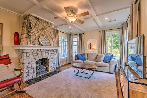 a living room with a couch and a fireplace at 2 Mi to Hot Springs Natl Park Hot Tub Haven! in Hot Springs