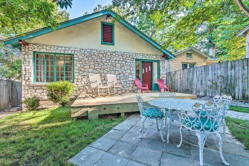 a patio with a table and chairs in front of a house at 2 Mi to Hot Springs Natl Park Hot Tub Haven! in Hot Springs