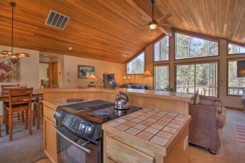 a kitchen with a stove top oven in a room at Sunriver Home with Hot Tub and 8 SHARC Passes in Sunriver