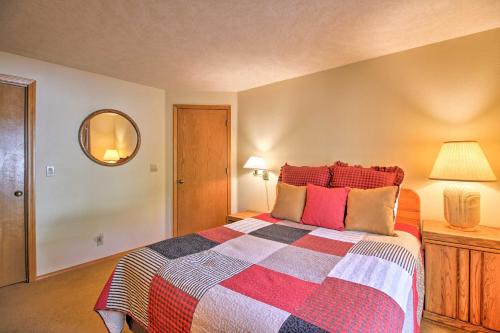 a bedroom with a bed with a colorful blanket at Sunriver Home with Hot Tub and 8 SHARC Passes in Sunriver