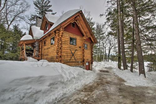 a log cabin in the woods in the snow at Waterfront Conway Vacation Rental with Deck! in Conway