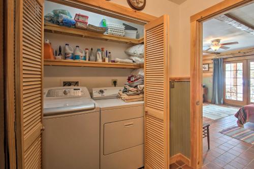 a washer and dryer in a kitchen with wooden cabinets at Waterfront Conway Vacation Rental with Deck! in Conway