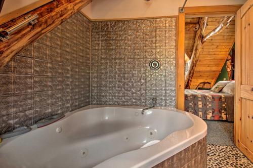 a white bath tub in a room with a bedroom at Waterfront Conway Vacation Rental with Deck! in Conway