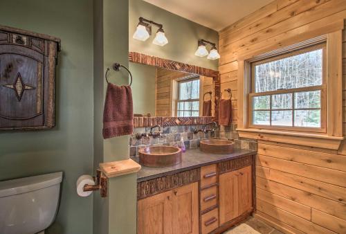 a bathroom with two sinks and a window at West Dover Cabin with Game Room, 4 Mi to Mt Snow! in West Dover