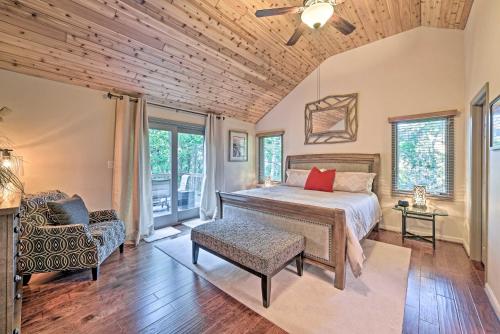 een slaapkamer met een bed, een stoel en ramen bij Wintergreen Resort Home with Deck Walk to Slopes in Wintergreen