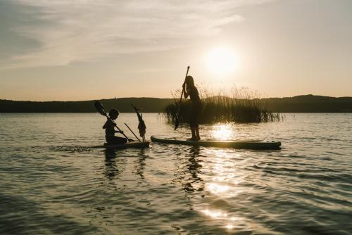 two people on a paddle board in the water at Insel der Sinne in Görlitz