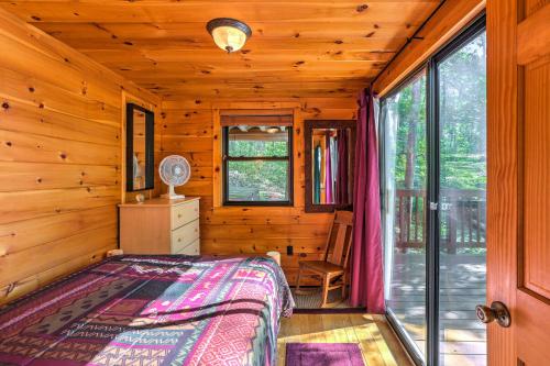 um quarto com uma cama num chalé de madeira em Hocking Hills Lake Gem with Hot Tub, Dock, 100 Acres em Hamden