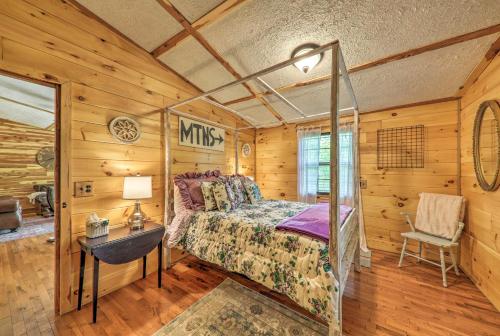 a bedroom with a bed in a wooden cabin at Getaway on Center Hill Lake with Decks and Water Views in Silver Point