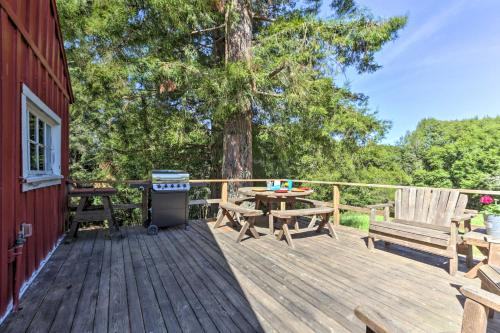 a wooden deck with a picnic table and two benches at Moonview Ranch on 20 Acres in Sonoma County! in Sebastopol