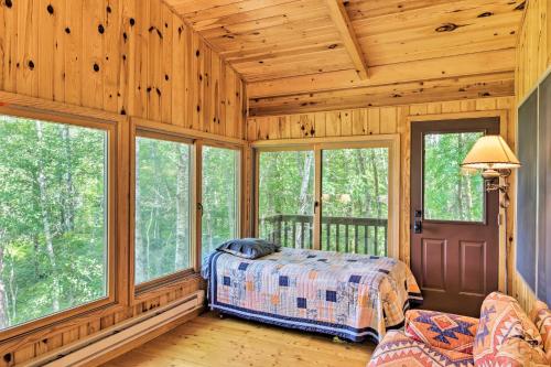 A bed or beds in a room at Rustic Cozy Cabin on Island Lake with Fire Pit, Dock