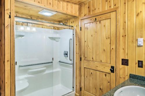 a bathroom with a glass shower and a sink at Rustic Cozy Cabin on Island Lake with Fire Pit, Dock in Arago