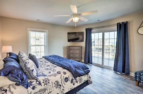 a bedroom with a bed and a ceiling fan at Spacious Murrells Inlet Hub with Pool, Walk to Shore in Myrtle Beach