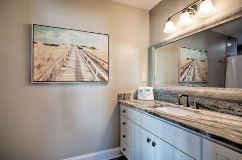 a bathroom with a sink and a mirror at Spacious Murrells Inlet Hub with Pool, Walk to Shore in Myrtle Beach