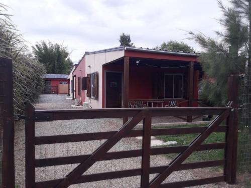 a building with a fence in front of it at Carmelo RIVERSIDE Bungalows in Carmelo