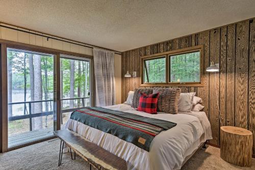 a bedroom with a bed and a large window at Arbor Vitae Home with Game Room Snowmobiles Welcome in Arbor Vitae